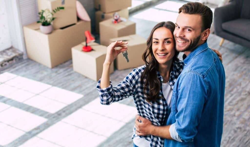 Young couple excitedly exploring a new home together.