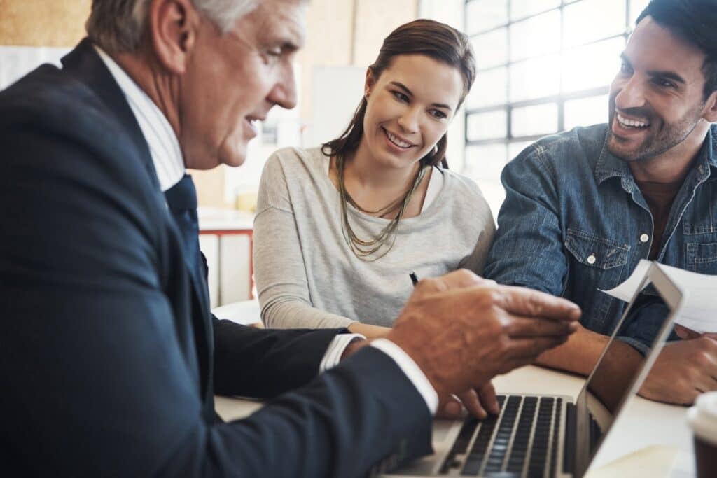 Working professionals discussing financial planning strategies for maximizing their 403b accounts.